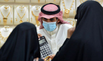 Saudis shop at a jewellery shop in the Tiba gold market in the capital Riyadh on June 29, 2020, after authorities announced a 10% increase in the VAT rate, to reach 15%, starting from first of July. (AFP)