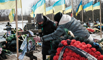 The wife (R) and sister of a Ukrainian serviceman died on January 17  visit his grave at a cemetery in Kramatorsk. (AFP)